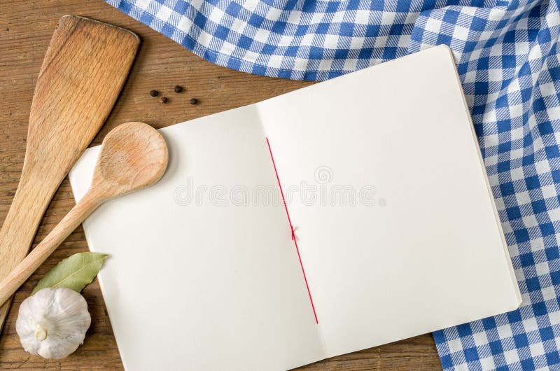Booklet with wooden spoons on a blue checkered tablecloth. Vintage rustic recipe book background stock images, royalty-free photos and pictures