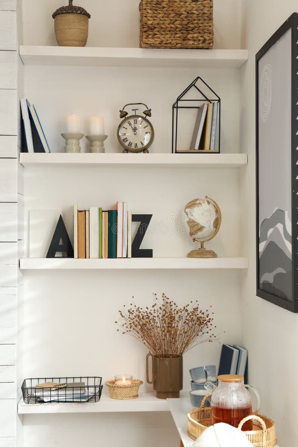 Bookends with books and decor on shelves indoors. Interior design. Bookends with books and decor on shelves indoors