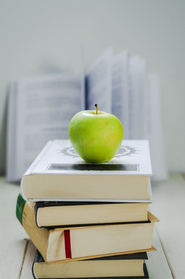 Books and apple stock photo. Image of table, background 184400058
