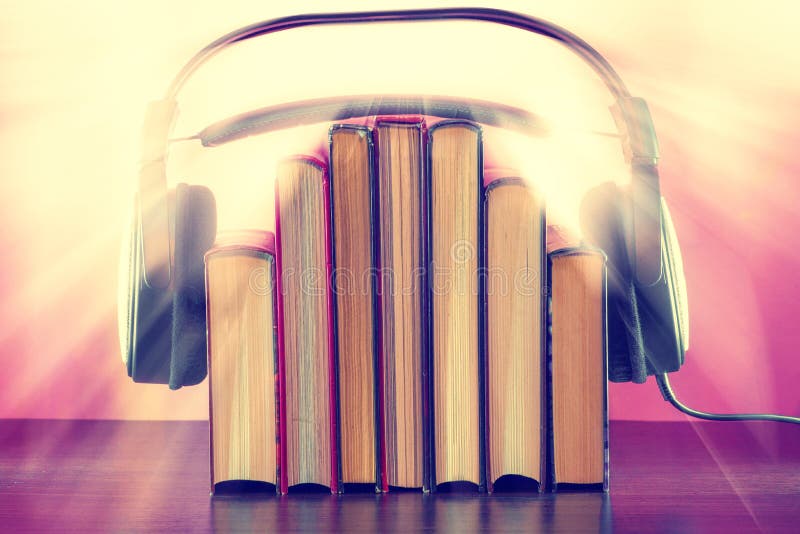 Books and headphones as an audiobook concept on a wooden table