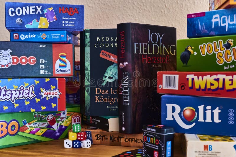 Books and Many Different Packs of Board Games Editorial Stock Photo