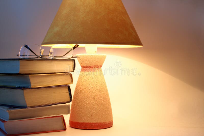 Books, spectacles and lamp