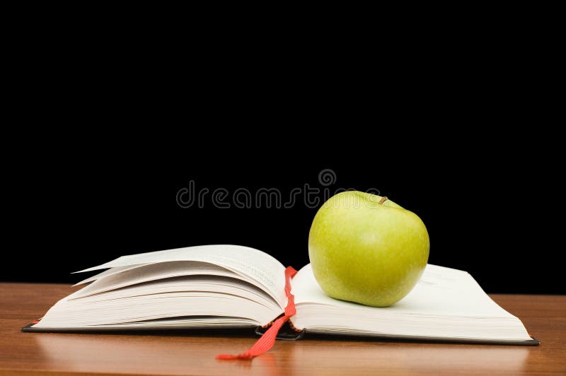 Books on a wooden table on a black background