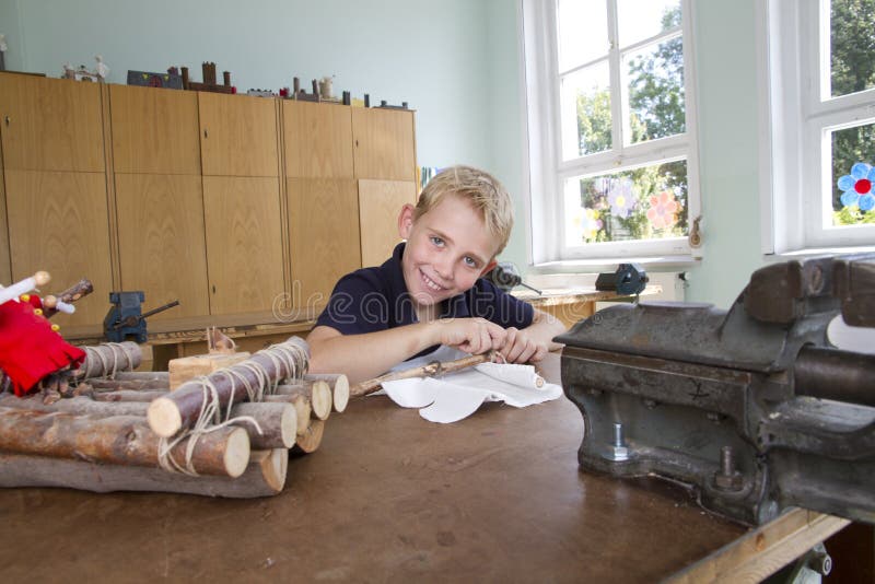 Little child is workin on a boat during school lesson. Little child is workin on a boat during school lesson.