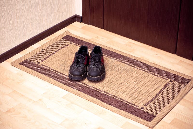 The boots on the doormat stock photo. Image of footwear 11497224