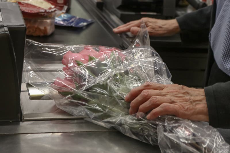 Boquet d'acquisto invecchiato anziano dell'uomo delle rose rosa al fuoco potato e selettivo del deposito - fotografia stock libera da diritti Boquet d'acquisto invecchiato anziano dell'uomo delle rose rosa al fuoco potato e selettivo del deposito - fotografia stock libera da diritti