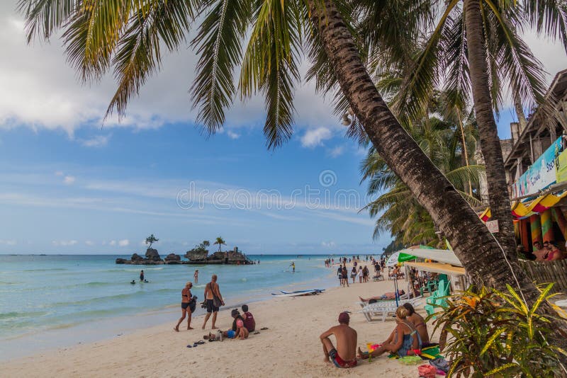 BORACAY, PHILIPPINES - FEBRUARY 3, 2018: Palms at the White Beach on Boracay island, Philippines. BORACAY, PHILIPPINES - FEBRUARY 3, 2018: Palms at the White Beach on Boracay island, Philippines