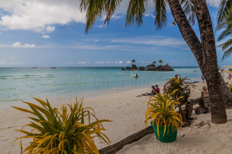 BORACAY, PHILIPPINES - FEBRUARY 3, 2018: Palms at the White Beach on Boracay island, Philippines. BORACAY, PHILIPPINES - FEBRUARY 3, 2018: Palms at the White Beach on Boracay island, Philippines
