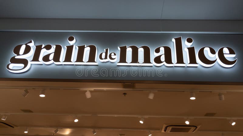 Grain De Malice Sign Brand and Logo Text of Shop Entrance Facade