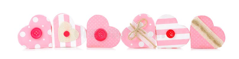 Long border of rustic pink Valentines heart shaped gift boxes isolated on a white background. Long border of rustic pink Valentines heart shaped gift boxes isolated on a white background