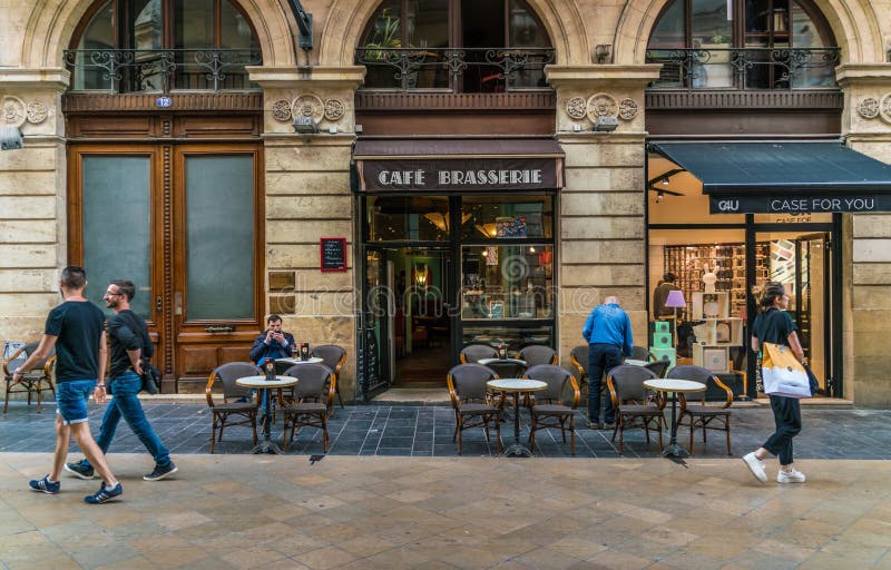 Bordeaux, France, 8 may 2018 -tourists and locals passing a Cafe Brasserie at the main shopping street `Rue Sainte-Catherine`. Bordeaux, France, 8 may 2018 -tourists and locals passing a Cafe Brasserie at the main shopping street `Rue Sainte-Catherine`