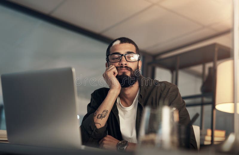Bored, design and laptop with programmer man in office at night for coding or computer engineering. Creative stock photography