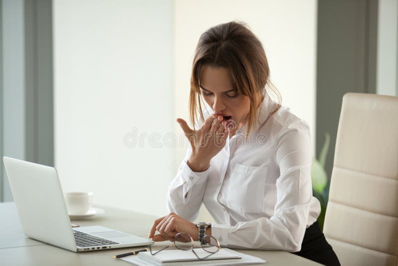 Bored impatient businesswoman yawning checking time tired of ove