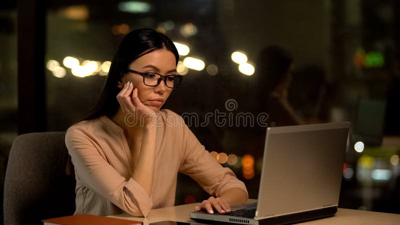 Bored female working on laptop, exhausted with overtime, lack of motivation royalty free stock photos Bored female working on laptop, exhausted with overtime, lack of motivation royalty free stock photos