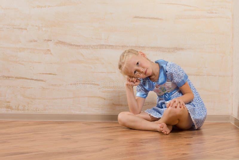 Bored little girl sitting watching and waiting