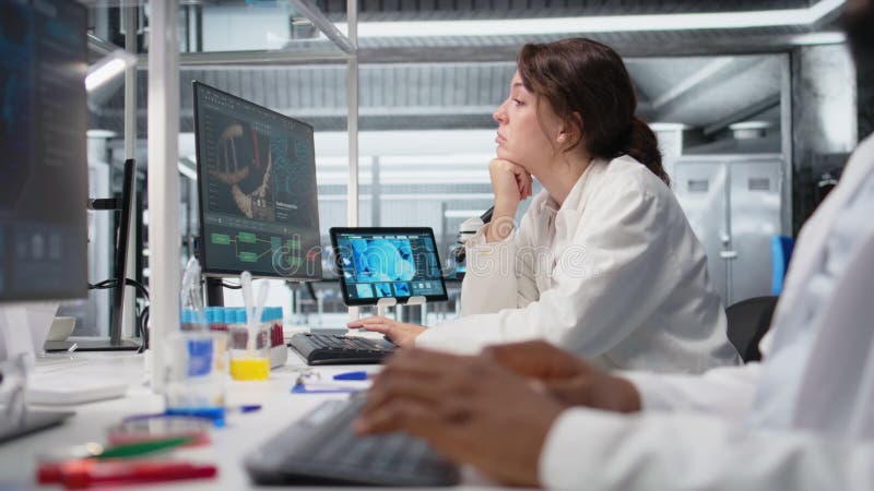 Bored medical laboratory technician using computer application stock video