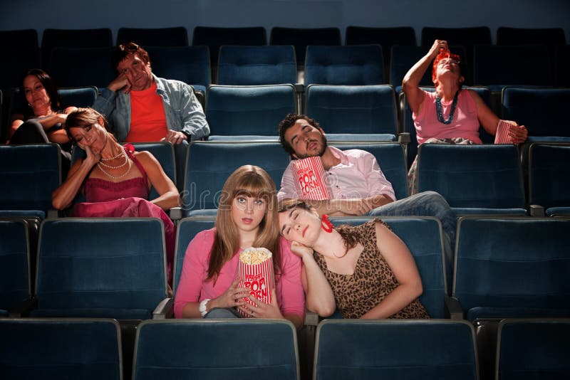 Bored people fall asleep in a theater. Bored people fall asleep in a theater