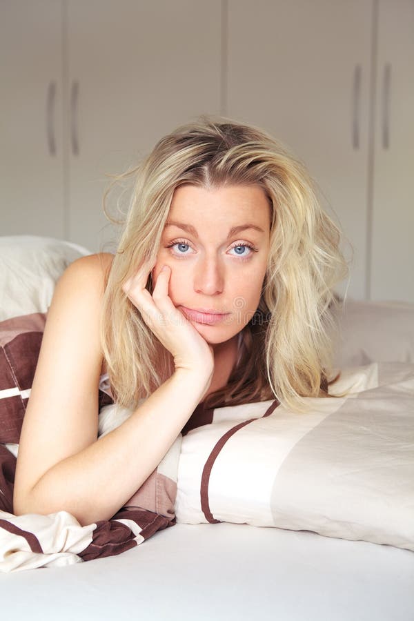 Bored woman confined to her bed royalty free stock photography