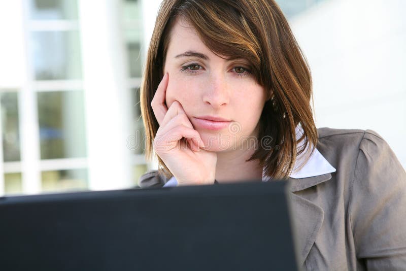 Bored Woman on Laptop Computer royalty free stock image