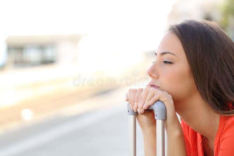 Bored woman waiting for delayed transportation royalty free stock photo