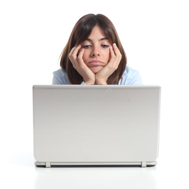 Bored woman watching a laptop royalty free stock photography