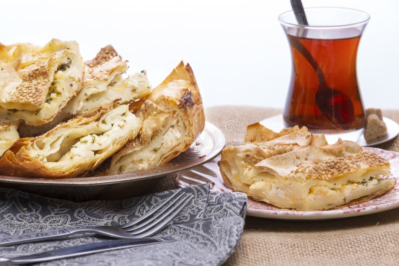 Turkish borek served at a party with cut portions heaped on a plate showing the crispy flaky texture of the yufka,or phyllo, pastry. Turkish borek served at a party with cut portions heaped on a plate showing the crispy flaky texture of the yufka,or phyllo, pastry