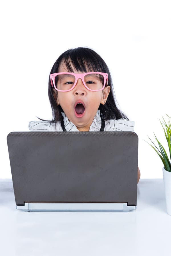Boring Asian Chinese little office lady using laptop in isolated white background. Boring kid white stock images, royalty-free photos and pictures