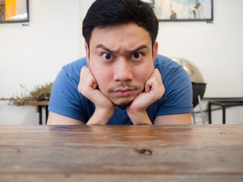 Boring and Serious Face Man Rest His Chin on His Hand. Stock Image