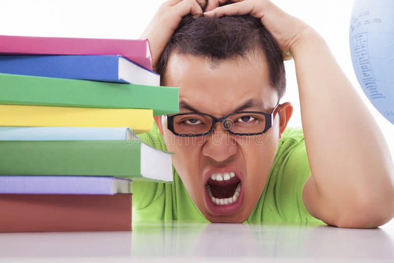 Boring and tired young man with many books stock images Boring and tired young man with many books stock images