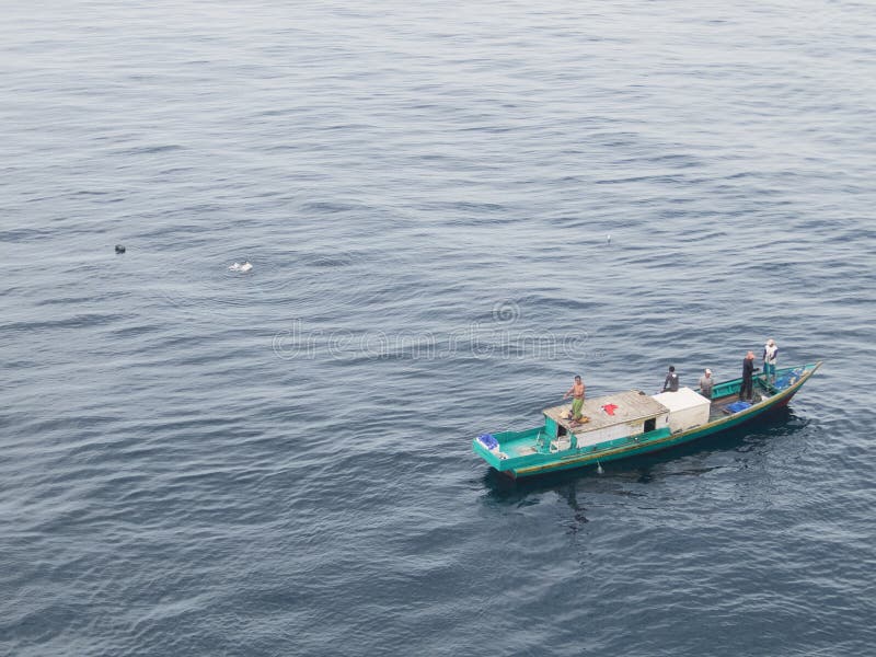 Borneo, Indonesia - 2015: Indonesian fisherman fishing offshore of Balikpapan city on Borneo Island