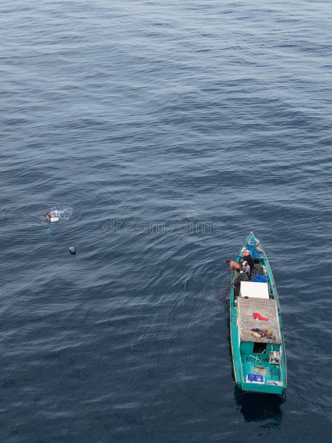 Borneo, Indonesia - 2015: Indonesian fisherman fishing offshore of Balikpapan city on Borneo Island