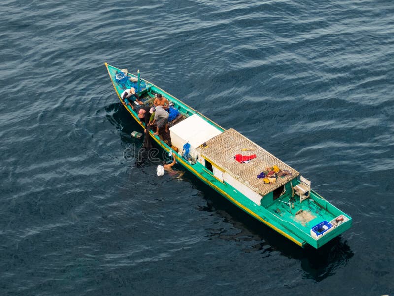 Borneo, Indonesia - 2015: Indonesian fisherman fishing offshore of Balikpapan city on Borneo Island