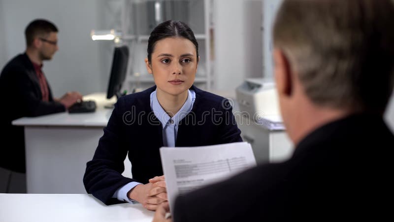 Boss checking female employee work results, probationary period at workplace royalty free stock images