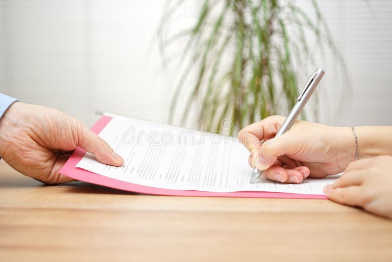 Boss gives employee dismissal contract to sign stock images Boss gives employee dismissal contract to sign stock images
