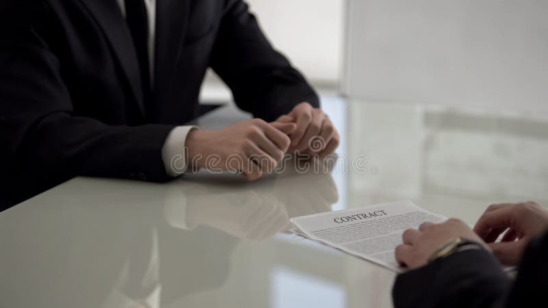 Boss giving employment contract to young job applicant, promotion assignment stock image Boss giving employment contract to young job applicant, promotion assignment stock image