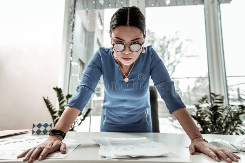 Dark-haired beautiful asian woman in a blue shirt looking bossy royalty free stock photos Dark-haired beautiful asian woman in a blue shirt looking bossy royalty free stock photos