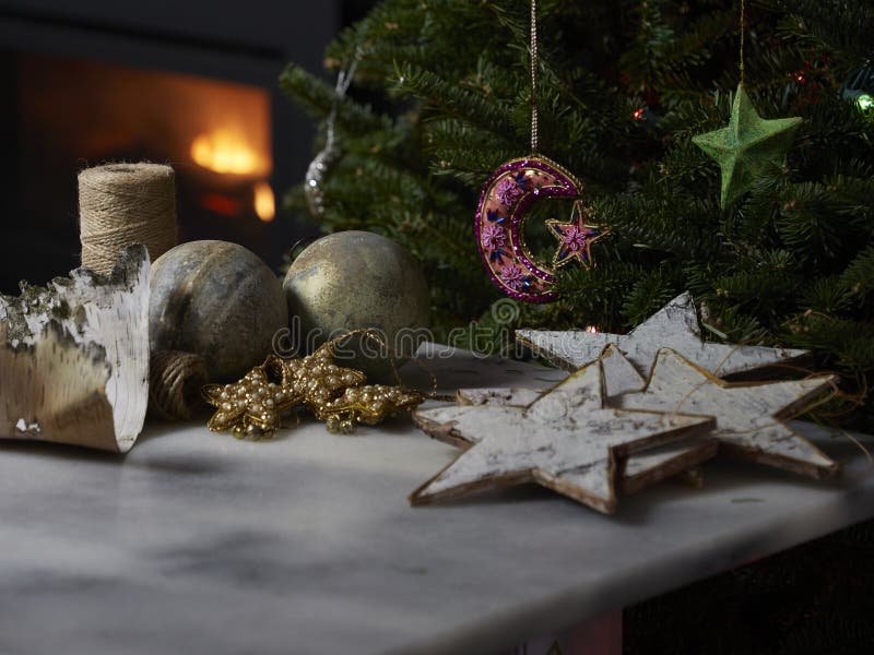 Home made birch bark Christmas ornaments, jute twine, birch bark with a fireplace and an evergreen tree with a moon and star decoration. Home made birch bark Christmas ornaments, jute twine, birch bark with a fireplace and an evergreen tree with a moon and star decoration