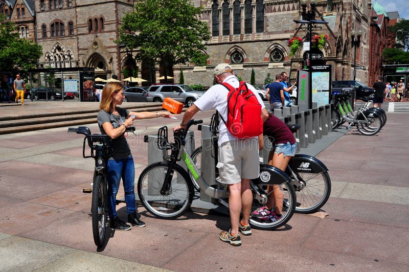 Visitors picking up city-sponsored rental bikes at a docking station in Boston, Massachusetts' Copley Square with the Old South Church on Dartmouth Street in the background. Visitors picking up city-sponsored rental bikes at a docking station in Boston, Massachusetts' Copley Square with the Old South Church on Dartmouth Street in the background.