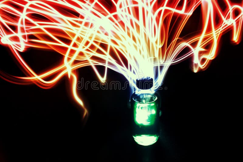 A glass bottle with magical light streaks coming out of it in the darkness. A great photo representing a magical potion or elixer. A glass bottle with magical light streaks coming out of it in the darkness. A great photo representing a magical potion or elixer.