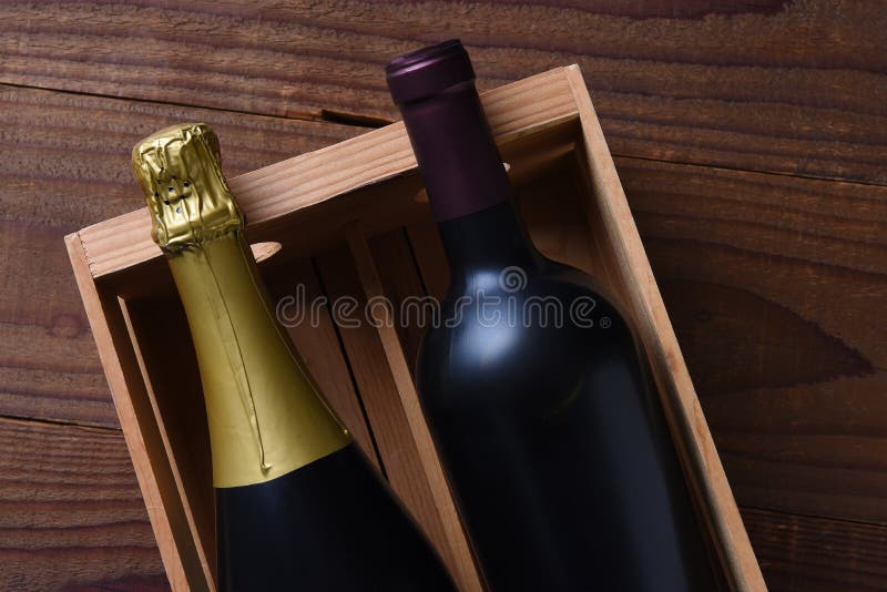 Botella de vino de Champán y de Cabernet Sauvignon en una caja de regalo de madera imagen de archivo libre de regalías Botella de vino de Champán y de Cabernet Sauvignon en una caja de regalo de madera imagen de archivo libre de regalías