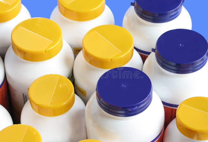 Bottles of nutritional supplements with colorful lids. Bottles of nutritional supplements with colorful lids