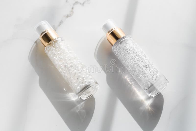 Bottiglia di siero e gel per la cura della pelle, lozione per l'umidità e emulsione di panna per sollevamento su marmo, cosmetici immagine stock Bottiglia di siero e gel per la cura della pelle, lozione per l'umidità e emulsione di panna per sollevamento su marmo, cosmetici immagine stock