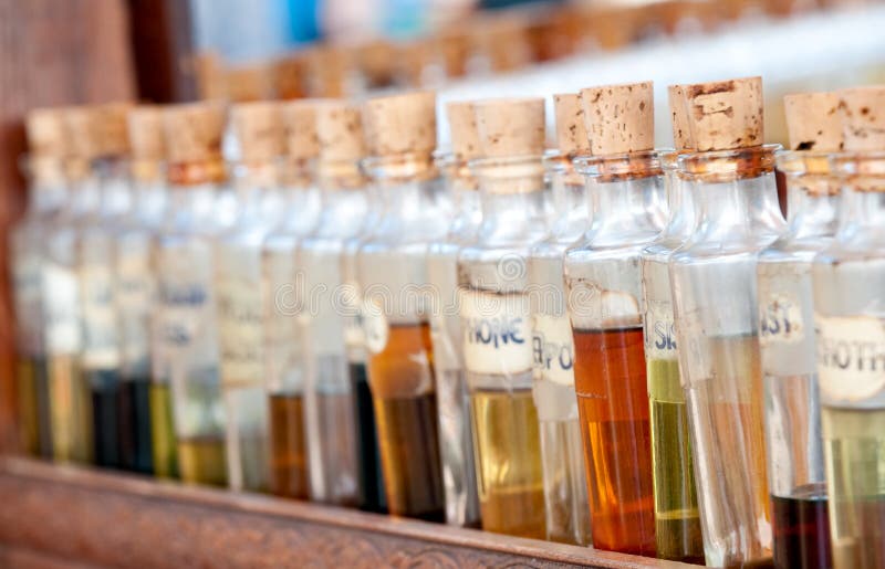 Bottles with basics oils, essentials and fragances aligned in a street market. USe of selective focus. Bottles with basics oils, essentials and fragances aligned in a street market. USe of selective focus