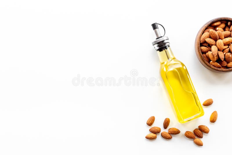 Bottle of Almond Oil with Almond Nuts. Extra Virgin Essence Oil Stock