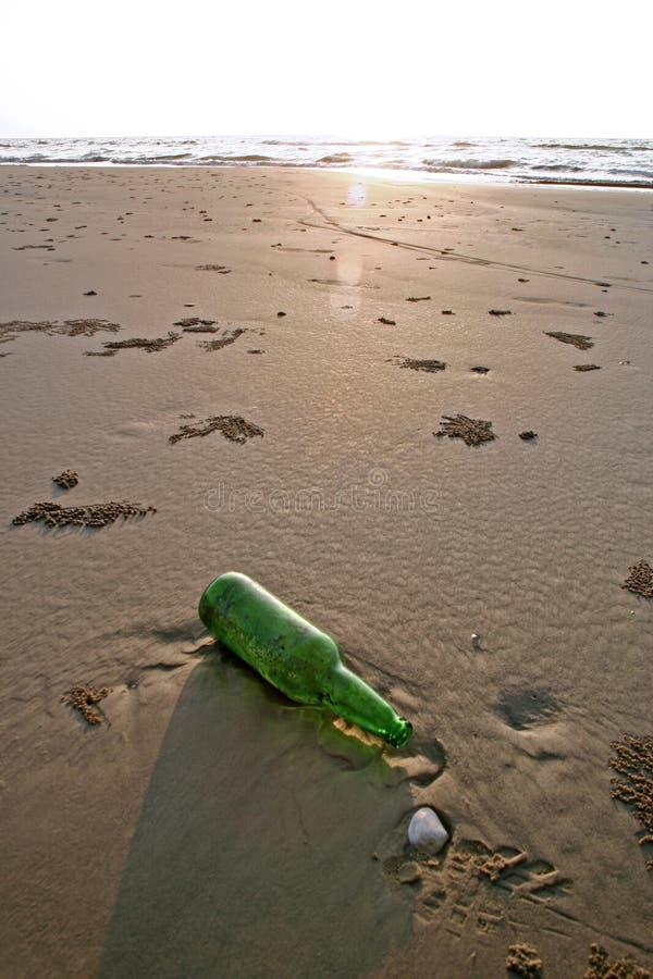 Bottle on a Beach stock photo. Image of green, sand, beach 593094