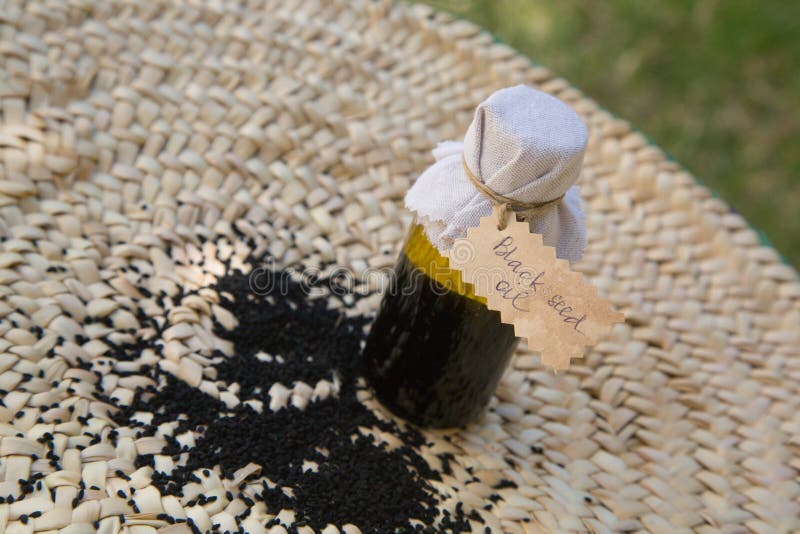 A bottle of black seed oil royalty free stock photo