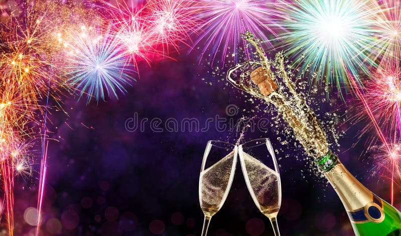 Bottle of champagne with glasses over fireworks background