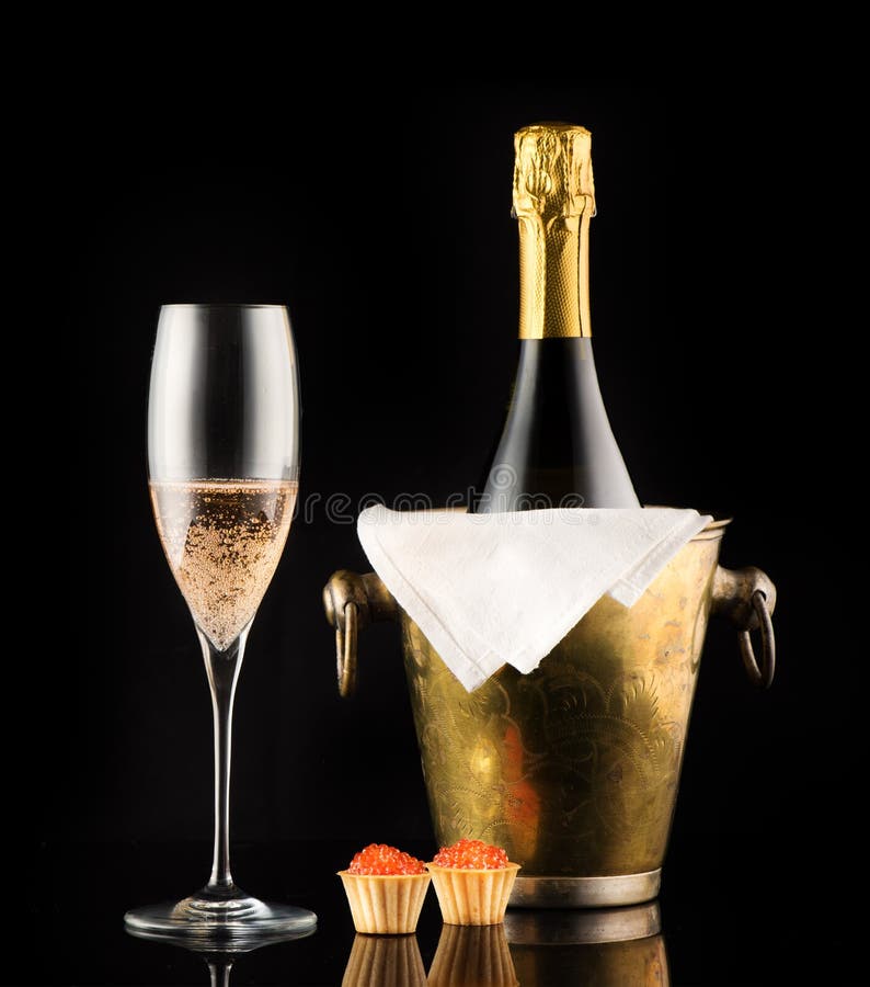 Bottle champagne and tartlets with red caviar stock photos Bottle champagne and tartlets with red caviar stock photos