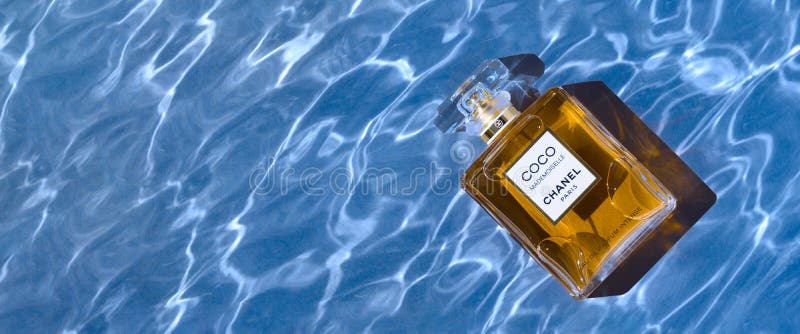 A Bottle of Chanel Perfume on the Background of the Texture of Water, with a Shadow Highlights. Coco Editorial Photo - Image of fragrance, yellow: 235702636