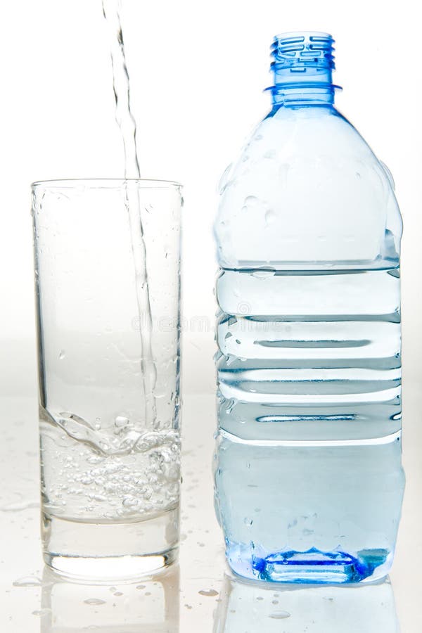 A bottle of fresh mineral water and a glass